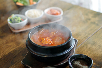Kimchi Soup with tofu and pork belly served in clay pot, One of the most loved of all the stews in Korean cuisine.
