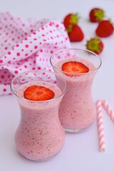 Strawberry smoothie in glass on white background
