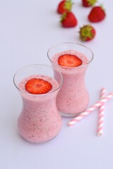 Strawberry smoothie in glass on white background
