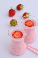 Strawberry smoothie in glass on white background