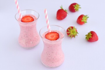 Strawberry smoothie in glass on white background