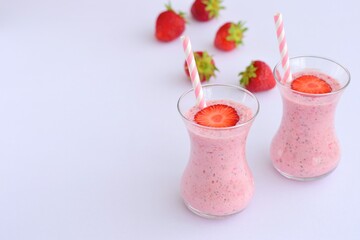 Strawberry smoothie in glass on white background