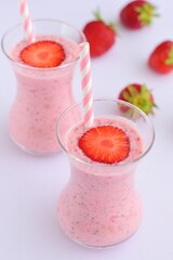 Strawberry smoothie in glass on white background