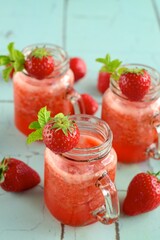 Fresh organic strawberry juice with mint in glass jar