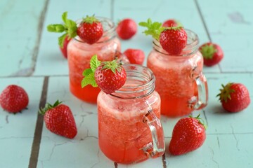 Fresh organic strawberry juice with mint in glass jar