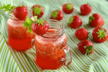 Fresh organic strawberry juice with mint in glass jar