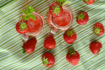 Fresh organic strawberry juice with mint in glass jar