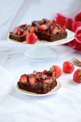 Strawberry chocolate brownies with fresh strawberry and chocolate sauce