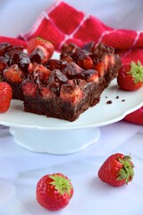 Strawberry chocolate brownies with fresh strawberry and chocolate sauce
