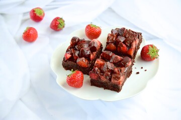 Strawberry chocolate brownies with fresh strawberry and chocolate sauce