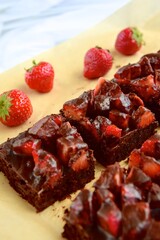 Strawberry chocolate brownies with fresh strawberry and chocolate sauce