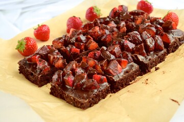 Strawberry chocolate brownies with fresh strawberry and chocolate sauce