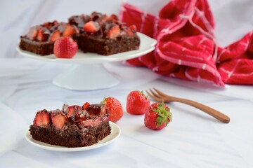 Strawberry chocolate brownies with fresh strawberry and chocolate sauce