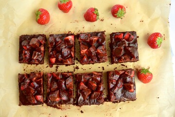 Strawberry chocolate brownies with fresh strawberry and chocolate sauce