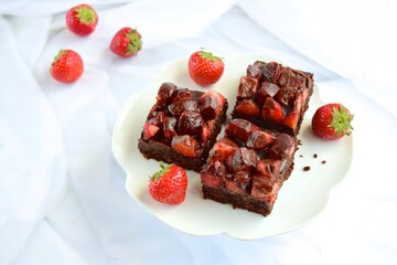 Strawberry chocolate brownies with fresh strawberry and chocolate sauce