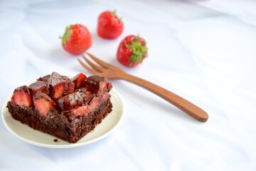 Strawberry chocolate brownies with fresh strawberry and chocolate sauce