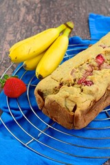 Strawberry banana yogurt cake with fresh strawberry and banana on rustic background