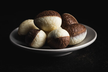 Chocolate easter eggs. Sweet candy eggs on plate.