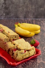 Strawberry banana yogurt cake with fresh strawberry and banana on rustic background