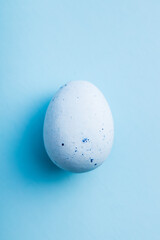 Blue chocolate easter egg. Sweet candy egg on blue background.