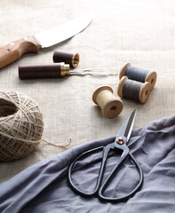 sewing threads with needles and scissors on a canvas.jpg