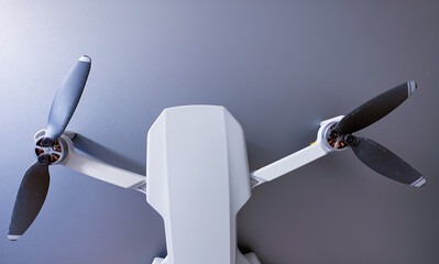 Small drone with propellers, metallic background 