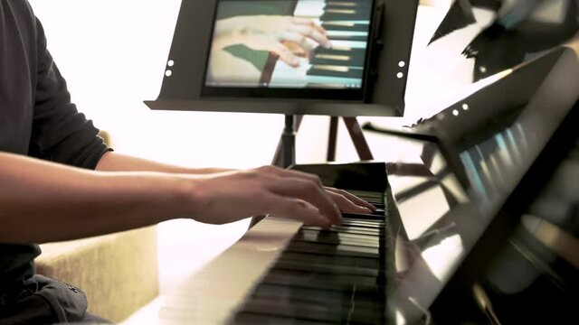 Medium close up of piano lessons online learning, Alternative way for education online class, Musical student practicing with online piano lesson, Social Distancing.