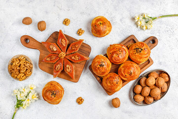 Traditional Azerbaijan holiday Novruz cookies baklava on the light  background with nuts and shekerbura,qogal,mutaki,flat lay,top view,space for copy