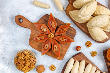 Traditional Azerbaijan holiday Novruz cookies baklava on the light  background with nuts and shekerbura,qogal,mutaki,flat lay,top view,space for copy