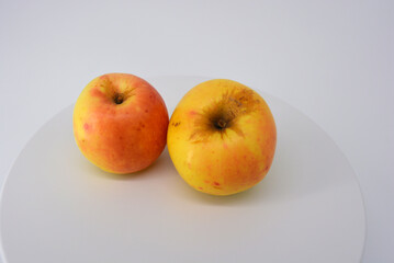 Small ripe yellow apples with red sideways located on a white background. 