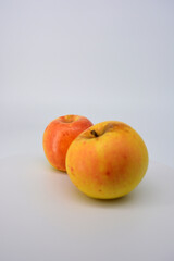 Small ripe yellow apples with red sideways located on a white background. 