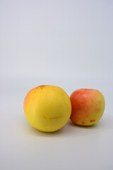 Small ripe yellow apples with red sideways located on a white background. 