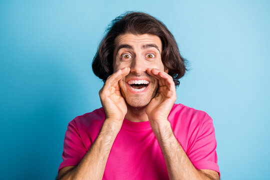 Photo of surprised man scream ads promo wear pink t-shirt isolated over blue color background