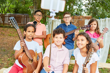 Children as a music band take selfie at summer camp