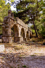 Fototapeta na wymiar Tekirova, Turkey - April 20, 2009: Aqueduct, ruins of Phaselis, a Greek and Roman city on the coast of ancient Lycia. Its ruins are located north of the modern city of Tekirova
