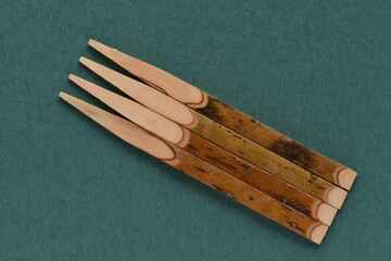 Wooden toothpicks isolated on blue background.