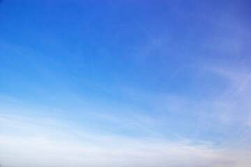 Blue sky background and white clouds soft focus, and copy space horizontal