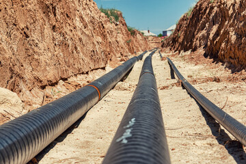Metal technological pipelines in a trench in the middle of the steppe