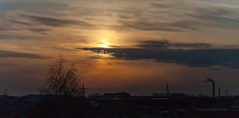 Fototapeta na wymiar Sunset over the industrial area of the city in winter