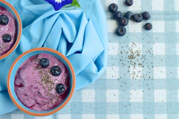 vegan blueberry smoothie bowl with chia seeds and acai powder