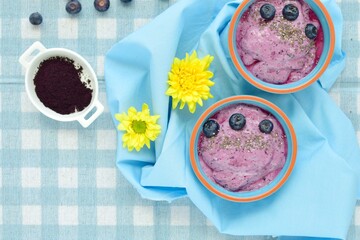 vegan blueberry chia smoothie bowl with acai powder. Flat lay
