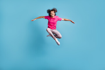 Fototapeta na wymiar Full length body size view of nice cheerful sporty graceful guy jumping dancing contemporary isolated over bright blue color background