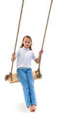 Blonde girl swinging on rope swing