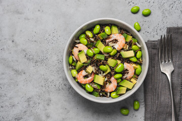 Shrimp salad with black rice, edamame beans, avocado. Healthy nutrition with seafood 