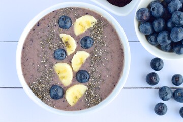 Acai berry smoothie bowl with banana, blueberry and chia seeds.  Top view