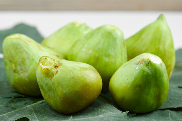 Fresh ripe green figs on the leaves
