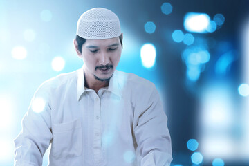 Asian Muslim man standing