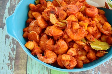 Sambal goreng kentang udang. Fried cubed potato with prawns cooked with coconut milk and spices (Indonesian food)