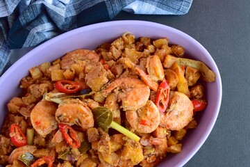 Sambal goreng kentang udang. Fried cubed potato with prawns cooked with coconut milk and spices (Indonesian food)
