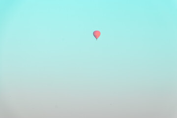 many hot air balloons floating over the Nile River in Luxor at sunrise 